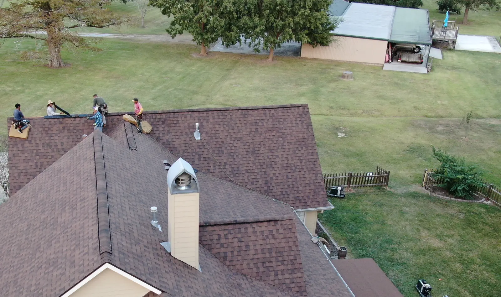 A Manifest crew working on a shingle roof, photographed from the air.